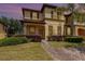 Charming two-story home with stucco exterior, dark shutters and landscaped front yard with brick pathway at 140 Napoli Dr, Davenport, FL 33897