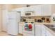 Bright kitchen with white appliances, cabinets, and countertops at 140 Napoli Dr, Davenport, FL 33897