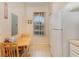 Eat-in kitchen featuring a window view, table, and full-sized refrigerator at 140 Napoli Dr, Davenport, FL 33897