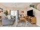 Comfortable living room featuring neutral furniture, a ceiling fan, and a TV at 140 Napoli Dr, Davenport, FL 33897