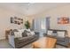 Bright living room with two sofas, ceiling fan, and artwork on the wall at 140 Napoli Dr, Davenport, FL 33897