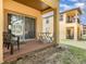 View of outdoor patio area featuring chairs, a sliding door, and lush greenery at 140 Napoli Dr, Davenport, FL 33897