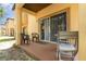 View of patio with two chairs, an outdoor rug, and a sliding glass door at 140 Napoli Dr, Davenport, FL 33897