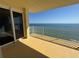 Spacious balcony showcasing ocean views with white railings and large glass sliding doors at 2300 N Atlantic Ave # 1502, Daytona Beach, FL 32118