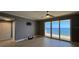 Bright bedroom featuring balcony access with ocean views and neutral color palette at 2300 N Atlantic Ave # 1502, Daytona Beach, FL 32118