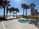 Outdoor hot tub surrounded by palm trees, with beach access and views in a sunny, welcoming community at 2300 N Atlantic Ave # 1502, Daytona Beach, FL 32118