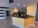 Kitchen featuring stainless appliances and dark countertops with an adjacent dining area at 2300 N Atlantic Ave # 1502, Daytona Beach, FL 32118