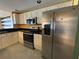 This kitchen features stainless steel appliances, granite countertops, and neutral colored cabinets and tile floor at 2300 N Atlantic Ave # 1502, Daytona Beach, FL 32118