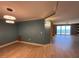 Bright living room with modern lighting, vinyl flooring, ocean view, and blue accent wall at 2300 N Atlantic Ave # 1502, Daytona Beach, FL 32118