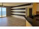 Bright living room featuring modern black and white striped wall, ocean view, and breakfast bar at 2300 N Atlantic Ave # 1502, Daytona Beach, FL 32118
