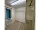 Walk-in closet with wire shelving and built-in cabinet and sliding door at 2300 N Atlantic Ave # 1502, Daytona Beach, FL 32118