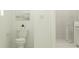 Well-lit bathroom with a toilet, shower, and minimalist decor offering a clean, modern look at 4536 Ochos Rios Pl, Kissimmee, FL 34758