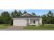 Charming one-story home with a two-car garage, stylish stonework, and beautifully landscaped front yard at 4536 Ochos Rios Pl, Kissimmee, FL 34758