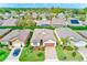 Aerial view of a charming neighborhood featuring a well-manicured house with lush landscaping at 518 Cortez Dr, Davenport, FL 33837