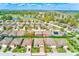 Aerial view of the property within a neighborhood with mature trees and nearby amenities, showcasing location at 518 Cortez Dr, Davenport, FL 33837