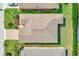 Aerial view of the home's roof, landscaping, and surrounding neighborhood featuring green lawns at 518 Cortez Dr, Davenport, FL 33837