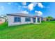 Spacious backyard with lush green grass and rear home exterior at 518 Cortez Dr, Davenport, FL 33837