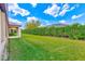 Large, well-maintained backyard featuring a green lawn with a privacy hedge at 518 Cortez Dr, Davenport, FL 33837