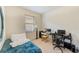Cozy bedroom featuring natural light, carpeted floors, and functional workspace with desk at 518 Cortez Dr, Davenport, FL 33837