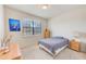 Well-lit bedroom with carpeted floor, a large window, and simple furnishings, including a bedside table and dresser at 518 Cortez Dr, Davenport, FL 33837