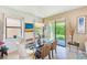 Elegant dining area with a glass table, wicker chairs, and sliding door access to the backyard at 518 Cortez Dr, Davenport, FL 33837