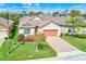 Beautiful home with manicured lawn, tidy flower beds, and brick-paved driveway at 518 Cortez Dr, Davenport, FL 33837