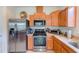 Well-equipped kitchen with stainless steel appliances and warm wood cabinetry at 518 Cortez Dr, Davenport, FL 33837