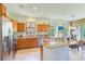 Modern kitchen with stainless steel appliances, granite countertops, and an island with bar seating at 518 Cortez Dr, Davenport, FL 33837