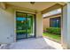 Outdoor patio area with sliding glass doors leading to a well-maintained backyard and green spaces at 518 Cortez Dr, Davenport, FL 33837