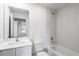 This bathroom has a modern design with a shower tub combo, a toilet, and vanity sink at 567 Bay Leaf Dr, Poinciana, FL 34759