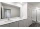 This bathroom boasts a double vanity with a modern design and a glass-enclosed shower at 567 Bay Leaf Dr, Poinciana, FL 34759