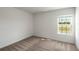 Carpeted bedroom with a window showing exterior light with neutral walls at 567 Bay Leaf Dr, Poinciana, FL 34759