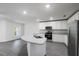 Spacious kitchen featuring a kitchen island, modern appliances, and gray wood-look flooring at 567 Bay Leaf Dr, Poinciana, FL 34759