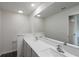 Bright bathroom featuring a double sink vanity with elegant faucets, and a large mirror at 576 Bay Leaf Dr, Poinciana, FL 34759