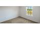 A bright bedroom with a window offering natural light and an exterior view at 576 Bay Leaf Dr, Poinciana, FL 34759