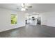Open-concept living room next to a kitchen and featuring modern grey flooring at 576 Bay Leaf Dr, Poinciana, FL 34759