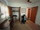 The bedroom is equipped with a sewing machine, open closet space and small refrigerator at 606 El Vedado Ave, Orlando, FL 32807