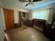 A bedroom featuring a ceiling fan, parquet floors, dresser, and one window covered with curtains at 606 El Vedado Ave, Orlando, FL 32807