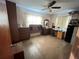 A bedroom featuring a ceiling fan, parquet floors, dresser, and two windows covered with curtains at 606 El Vedado Ave, Orlando, FL 32807