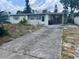 Exterior of home with mature landscaping, covered carport and concrete driveway at 606 El Vedado Ave, Orlando, FL 32807
