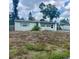 Modest single-story home with a flat roof, small windows, and front yard overgrown with weeds at 606 El Vedado Ave, Orlando, FL 32807