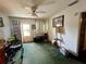 A traditional living room featuring a ceiling fan and carpeted flooring at 606 El Vedado Ave, Orlando, FL 32807