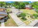 An aerial view of the property displaying mature trees, long driveway, and proximity to neighboring homes at 830 Polk St, Orlando, FL 32805