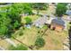 An aerial view of the property showing the spacious, fenced backyard, mature trees, and shed at 830 Polk St, Orlando, FL 32805