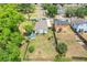 An aerial view of the property showcasing a spacious, fenced backyard, shed, and adjacent neighborhood at 830 Polk St, Orlando, FL 32805