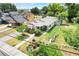 An aerial view of the property featuring a long driveway, mature trees, and proximity to nearby residences at 830 Polk St, Orlando, FL 32805