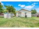 A cozy backyard area with a small shed and some yard chairs at 830 Polk St, Orlando, FL 32805