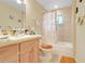 Bathroom featuring a tile shower, vanity with mirror, and peach accents at 830 Polk St, Orlando, FL 32805