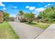 View of the side of the home with a long driveway and landscaping at 830 Polk St, Orlando, FL 32805