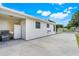 Exterior view of the house with a large parking area and a fenced-in back area at 830 Polk St, Orlando, FL 32805